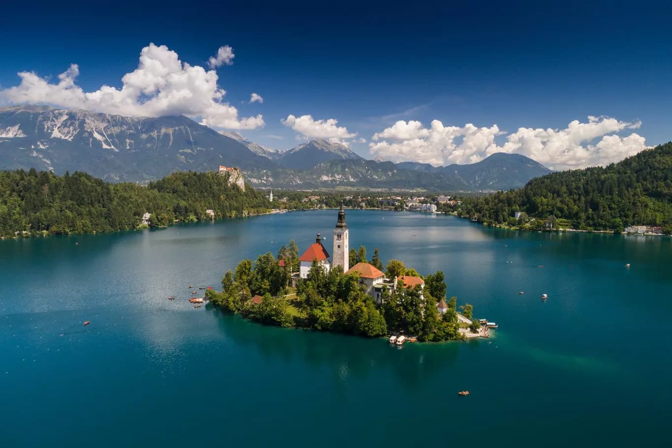 Lake Bled island church surrounded by turquoise water with mountains in Slovenia.