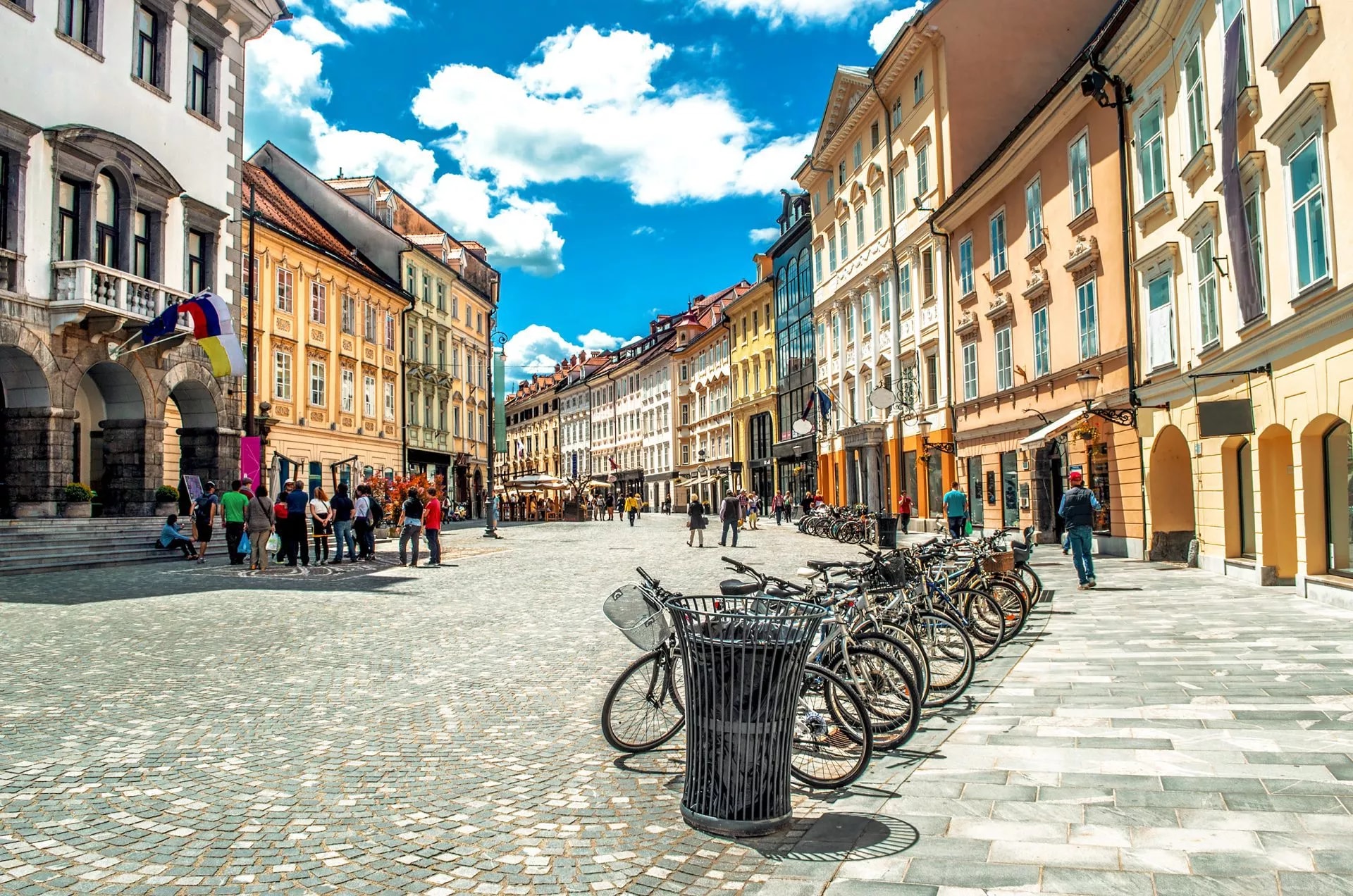 Cobblestone square in Ljubljana Old Town with historic buildings and parked bicycles.